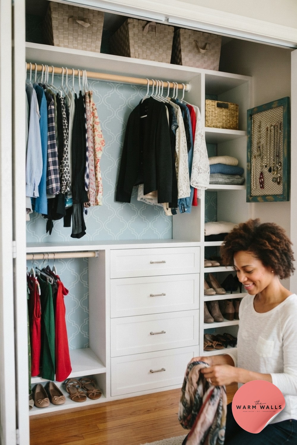 Low white cube closet shelving with pastel bins puts a child's clothes and toys within easy reach.