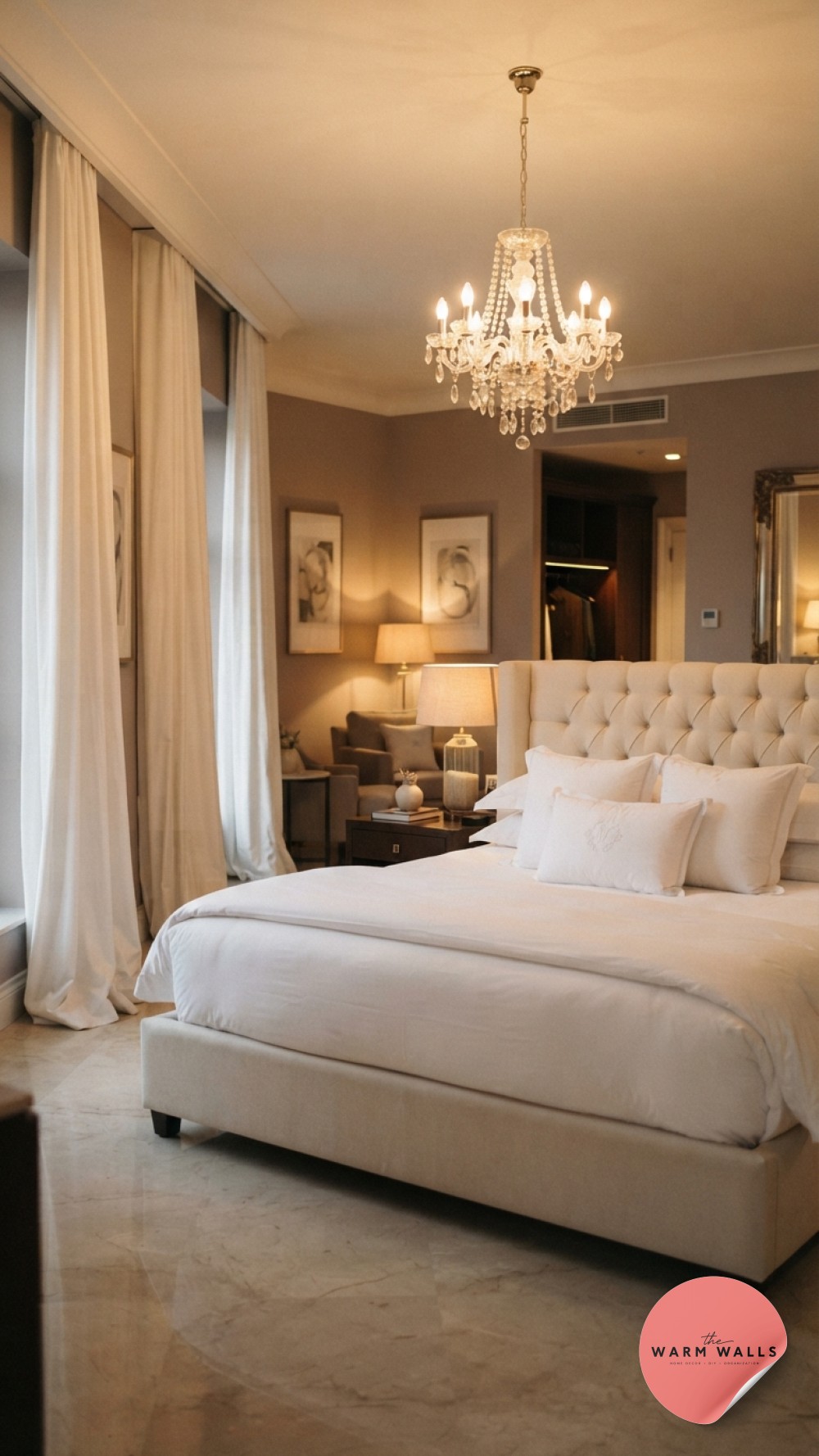 Opulent hotel-style luxury white bedroom aesthetic with a crystal chandelier and pooling curtains